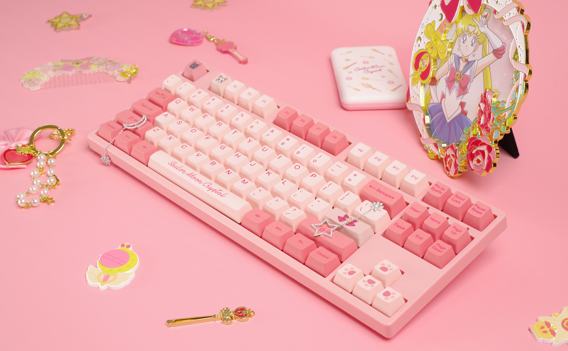 Akko Sailor Moon Crystal 3087 Keyboard surrounded by various Sailor Moon-themed accessories on a clean surface