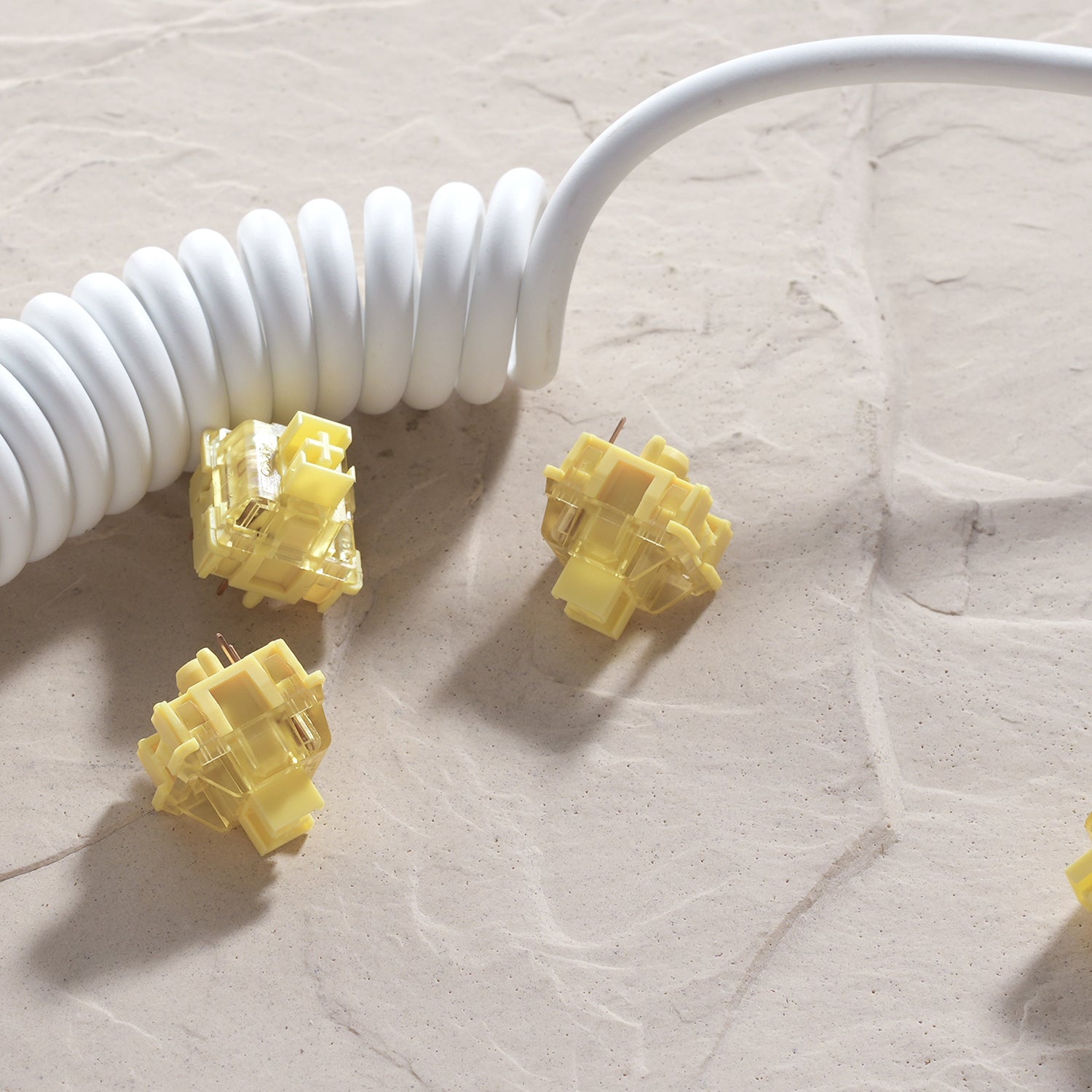 three Akko V3 Cream Yellow Pro Switches